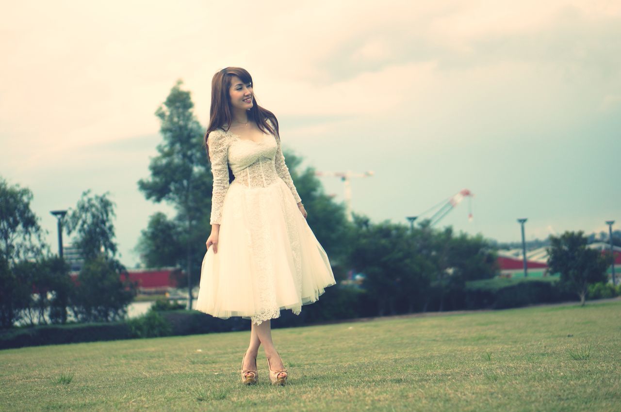 WOMAN STANDING ON FIELD