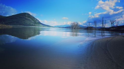 Scenic view of lake against blue sky