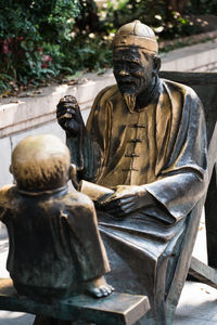 Buddhist statues, old man and young boy