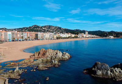 Panoramic view of sea and buildings against sky