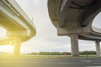 Low angle view of bridge against sky in city