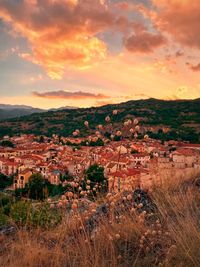 Aerial view of townscape against sky during sunset