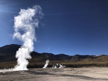 Scenic view of volcanic landscape against clear blue sky