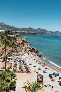 Panoramic view of beach against clear blue sky