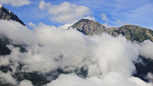 Low angle view of snowcapped mountains against sky