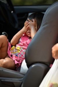 Cute girl sitting in car