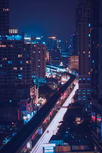 High angle view of illuminated street amidst buildings in city