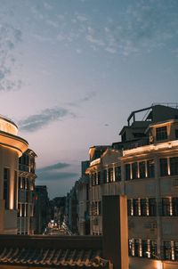 Buildings in city at sunset