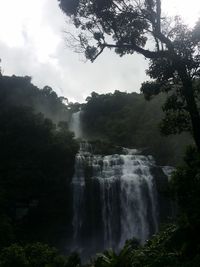 Scenic view of waterfall against sky