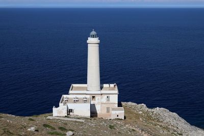 High angle view of lighthouse by sea against building