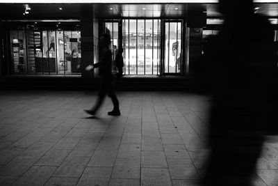 People walking in corridor of building