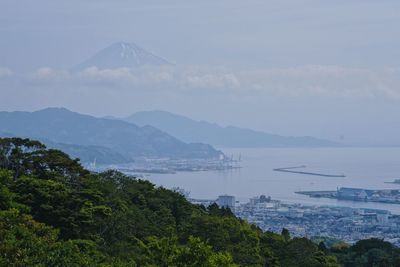 High angle view of sea and mountains against sky