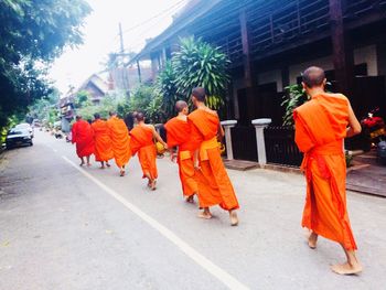 People in traditional clothing walking on street