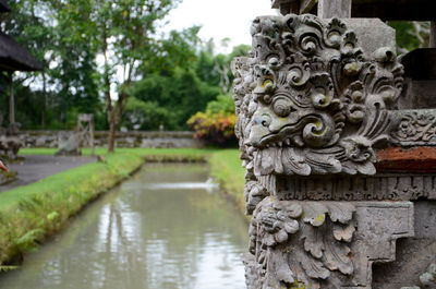 Close-up of stone wall against trees