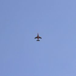 Low angle view of helicopter flying against clear sky