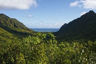 Scenic view of sea and mountains against sky