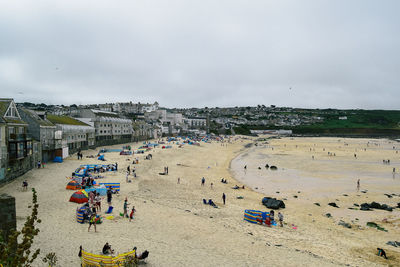 High angle view of people at beach against sky