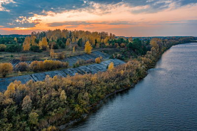 Scenic view of river against sky during sunset