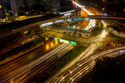 High angle view of light trails on road at night