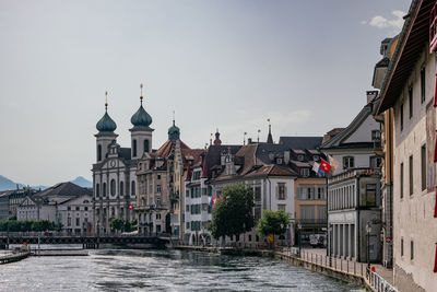 Canal amidst buildings in town against sky