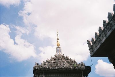 Low angle view of historic temple against cloudy sky