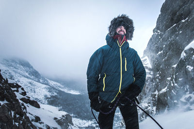 Man standing on snowcapped mountain