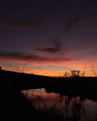 Scenic view of lake against romantic sky at sunset