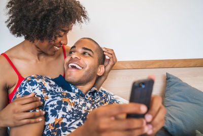 Young couple holding mobile phone