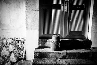 Man sitting on staircase against building