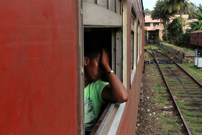 Rear view of boy on railroad track