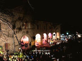 Group of people in front of building at night