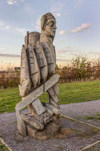 Statue in park against sky