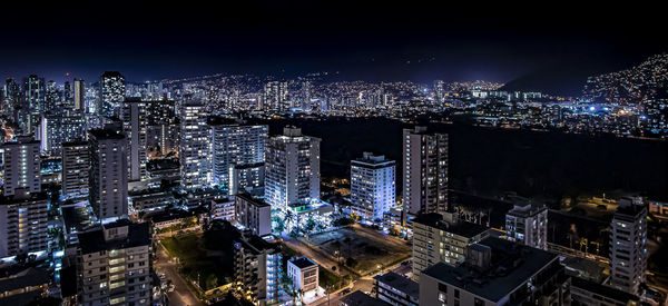 High angle view of illuminated city buildings at night