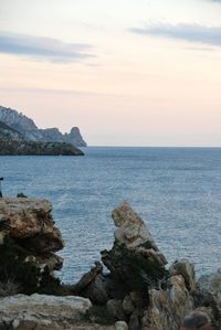 Scenic view of rocks in sea against sky