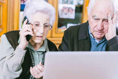 Mid adult man using mobile phone at home