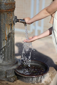 Midsection of woman pouring water