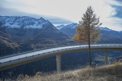 Road by mountain against sky