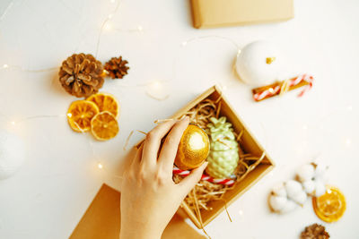 High angle view of woman holding food on table