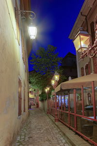 Street amidst buildings at night