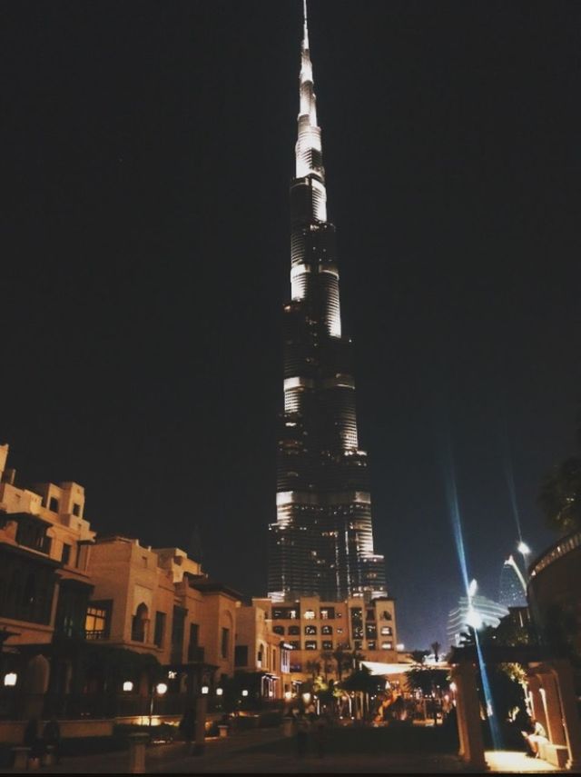 building exterior, architecture, night, illuminated, built structure, city, clear sky, low angle view, tower, tall - high, copy space, travel destinations, street light, city life, capital cities, famous place, skyscraper, sky, building, outdoors