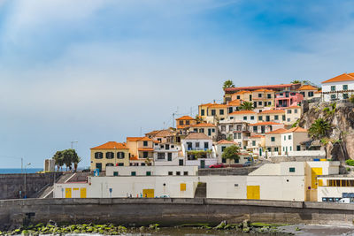 Residential buildings against sky in city