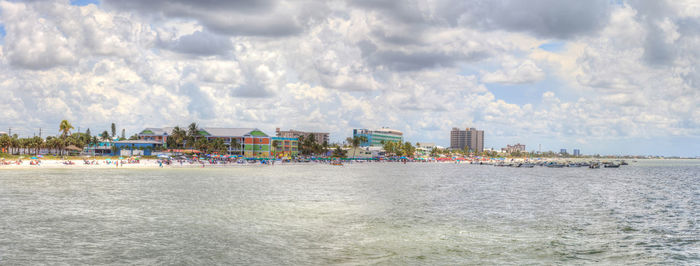 Panoramic view of sea against buildings