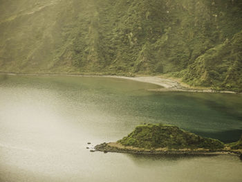 Scenic view of lake by trees against mountain