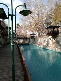 Scenic view of swimming pool by lake against sky