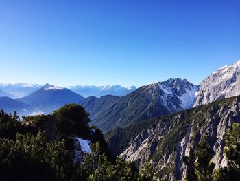 Scenic view of mountains against clear blue sky