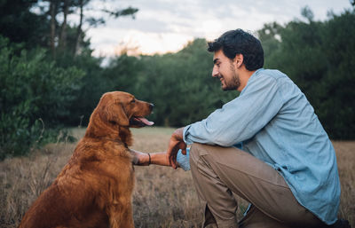 Young man with dog on landscape