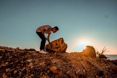 Low angle view of rock formation against sky at sunset