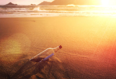 Scenic view of beach against sky during sunset