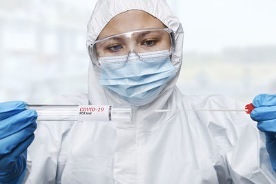 Portrait of female doctor wearing surgical mask in laboratory