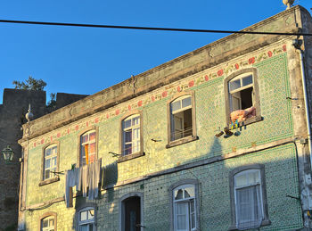 Low angle view of old building against clear sky